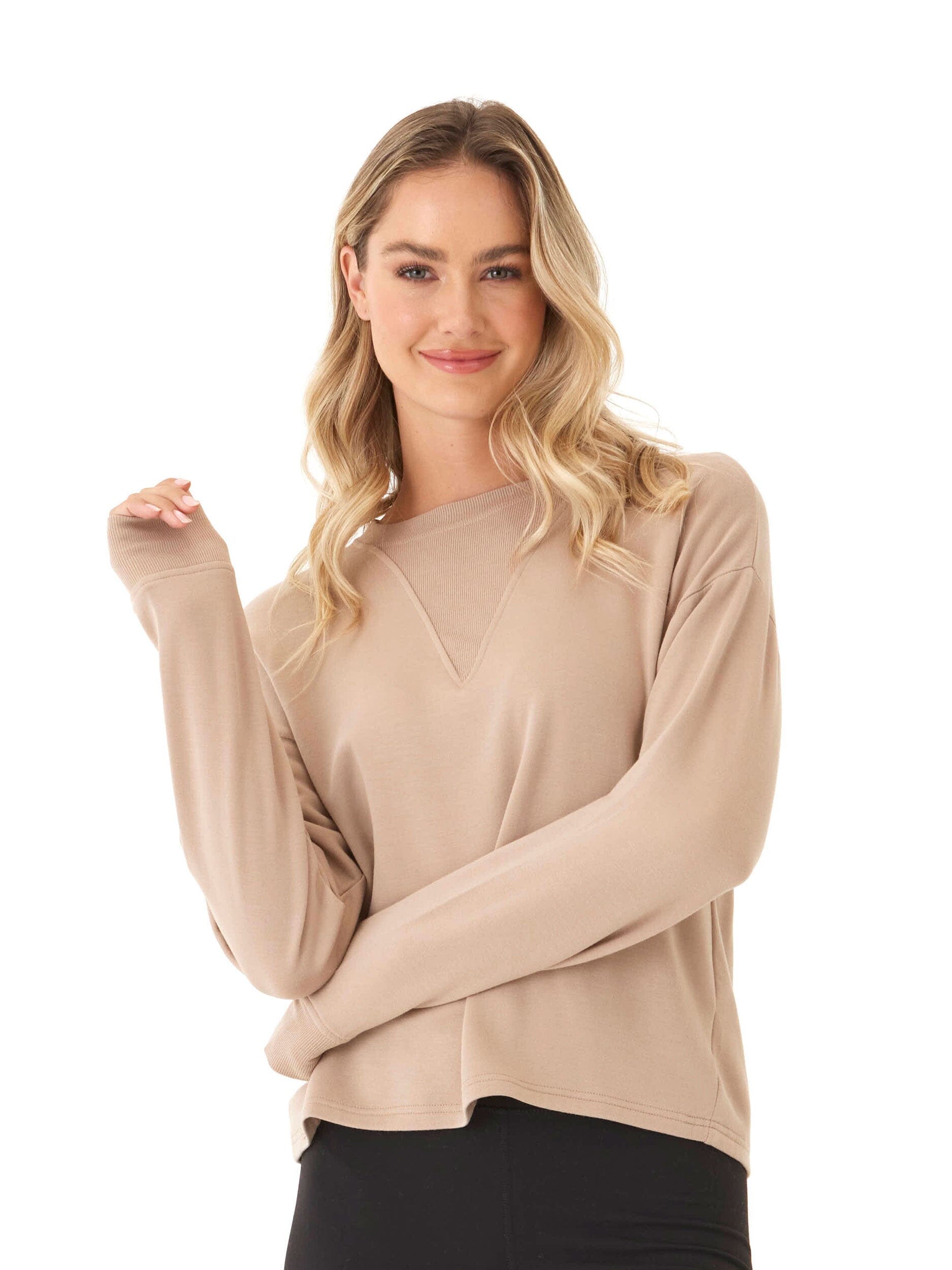 Model wearing a cozy Feather Fleece Panel Pullover with ribbed neck and cuff detailing.