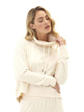 Woman wearing a cream Shai Cozy Fleece Cowl Neck Pullover with thumbholes