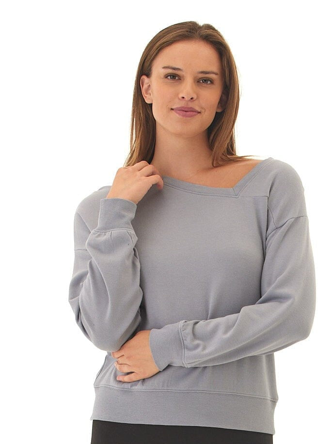 Woman wearing a grey feather fleece pullover with an asymmetrical neckline.