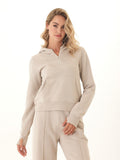 Women wearing a Tyra triblend fleece quarter zip hoodie in taupe