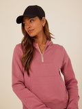 Women wearing a Mauve Tyra Triblend Fleece Quarter Zip Hoodie with thumbholes and pockets.