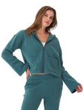 Woman wearing a comfortable teal triblend fleece hoodie with wide sleeves and front pockets