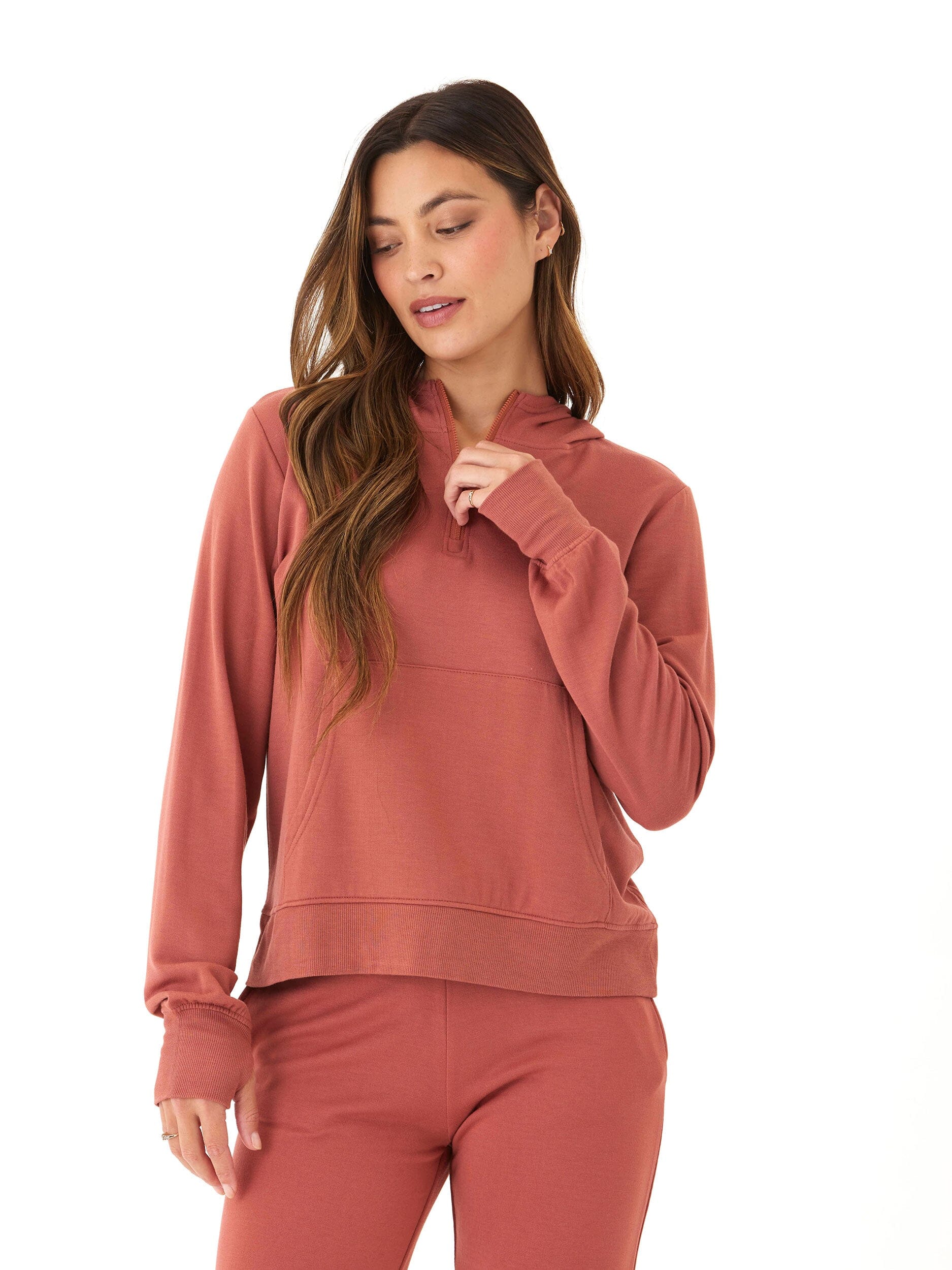 Women's Natia Feather Fleece 1/4-Zip Hoodie in rust featuring a front pocket and thumbhole sleeves.