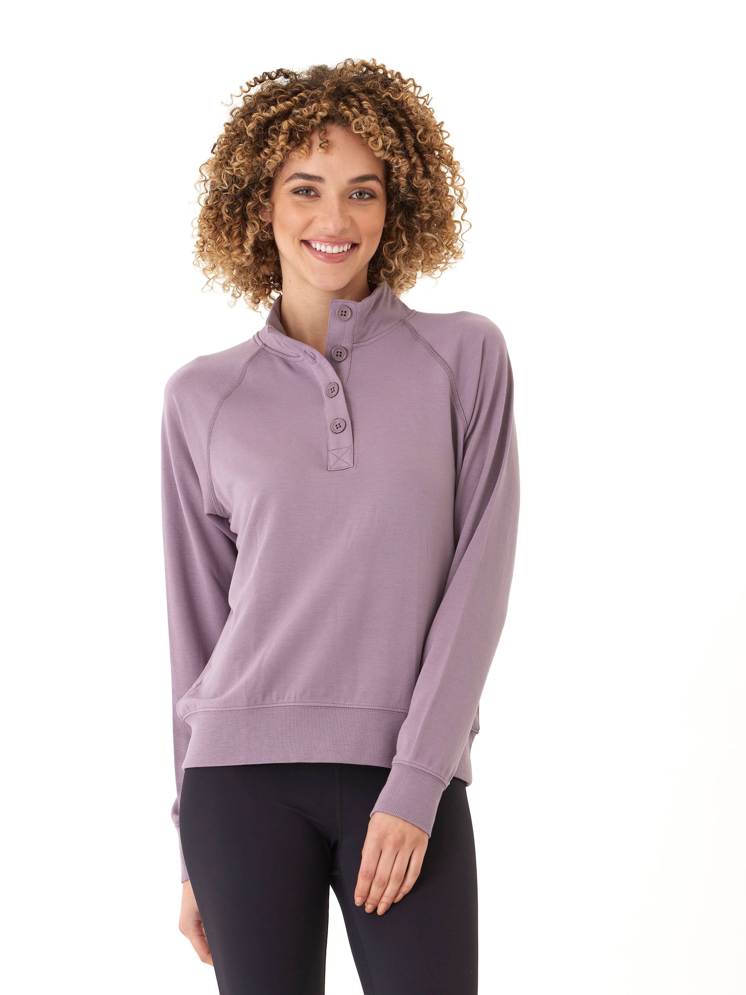 Woman wearing a dusty-purple Candace modal terry raglan pullover with a mock neck.