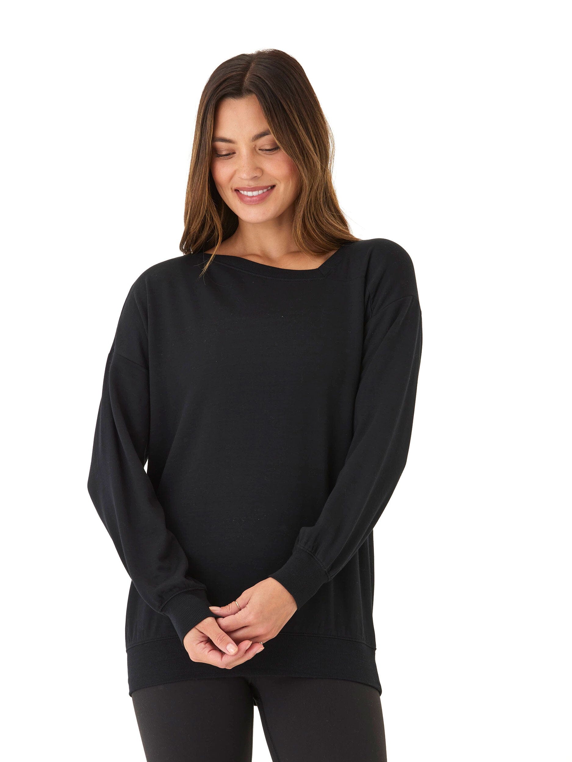 Woman wearing a black Merida Feather Fleece Asymmetrical Tunic with a high neckline and unique hemline.