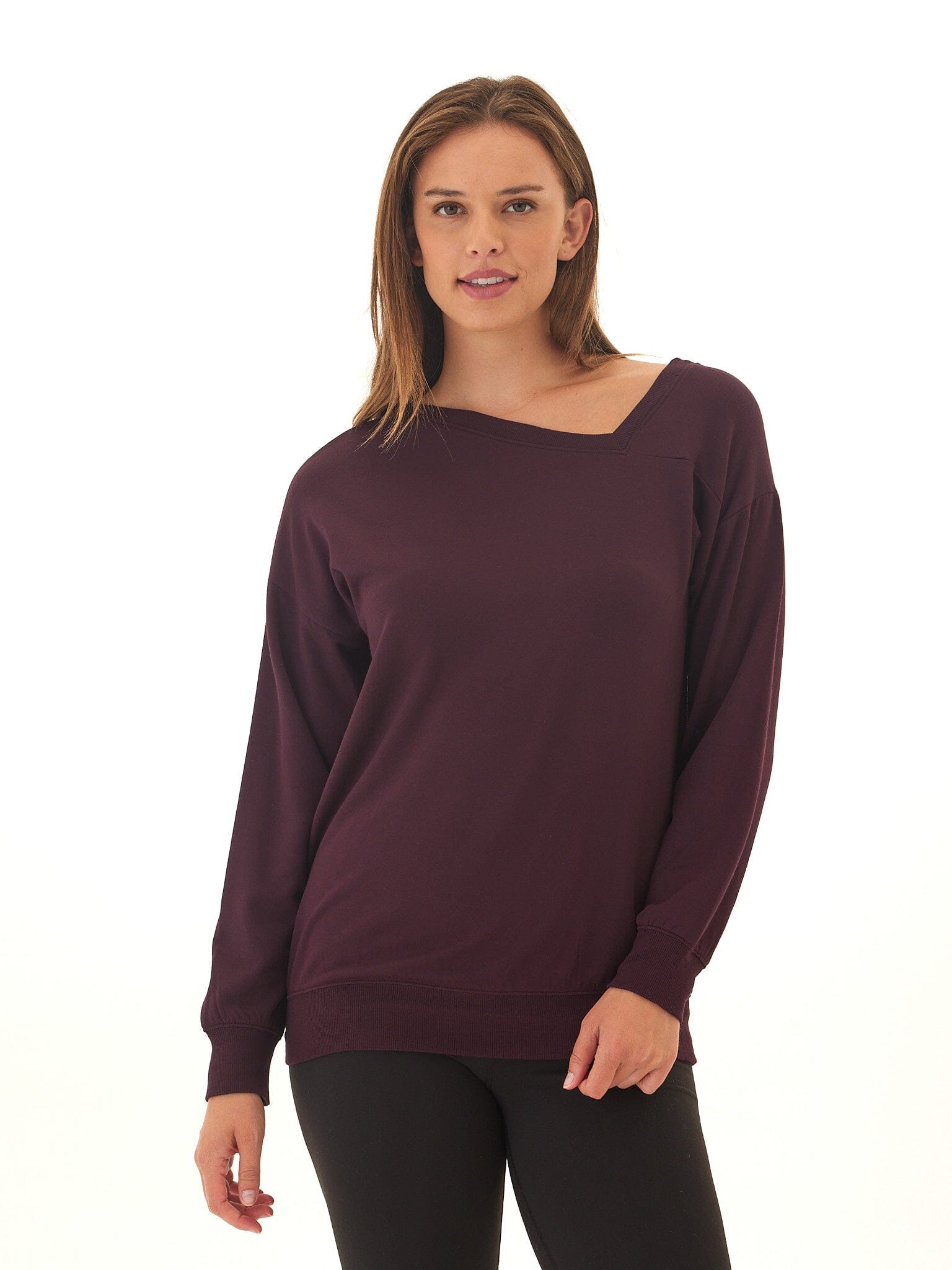 Women wearing a deep plum feather fleece asymmetrical tunic with a relaxed fit