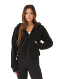 Women wearing a black relaxed-fit sherpa full zip hoodie with a lined hood and rib details.