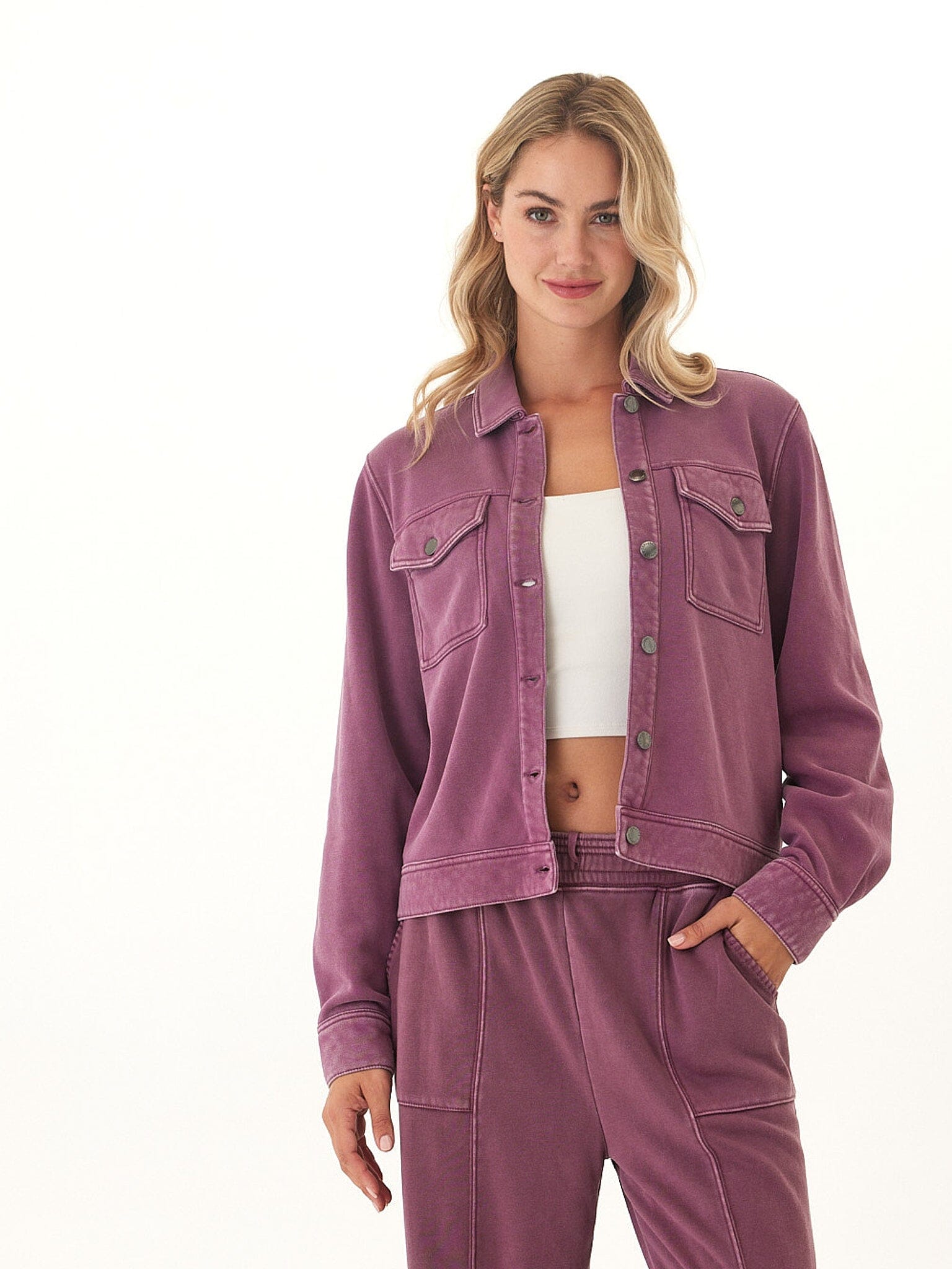 A relaxed fit, long-sleeve mineral wash plum knit jacket with a collared neckline and button-down closure.