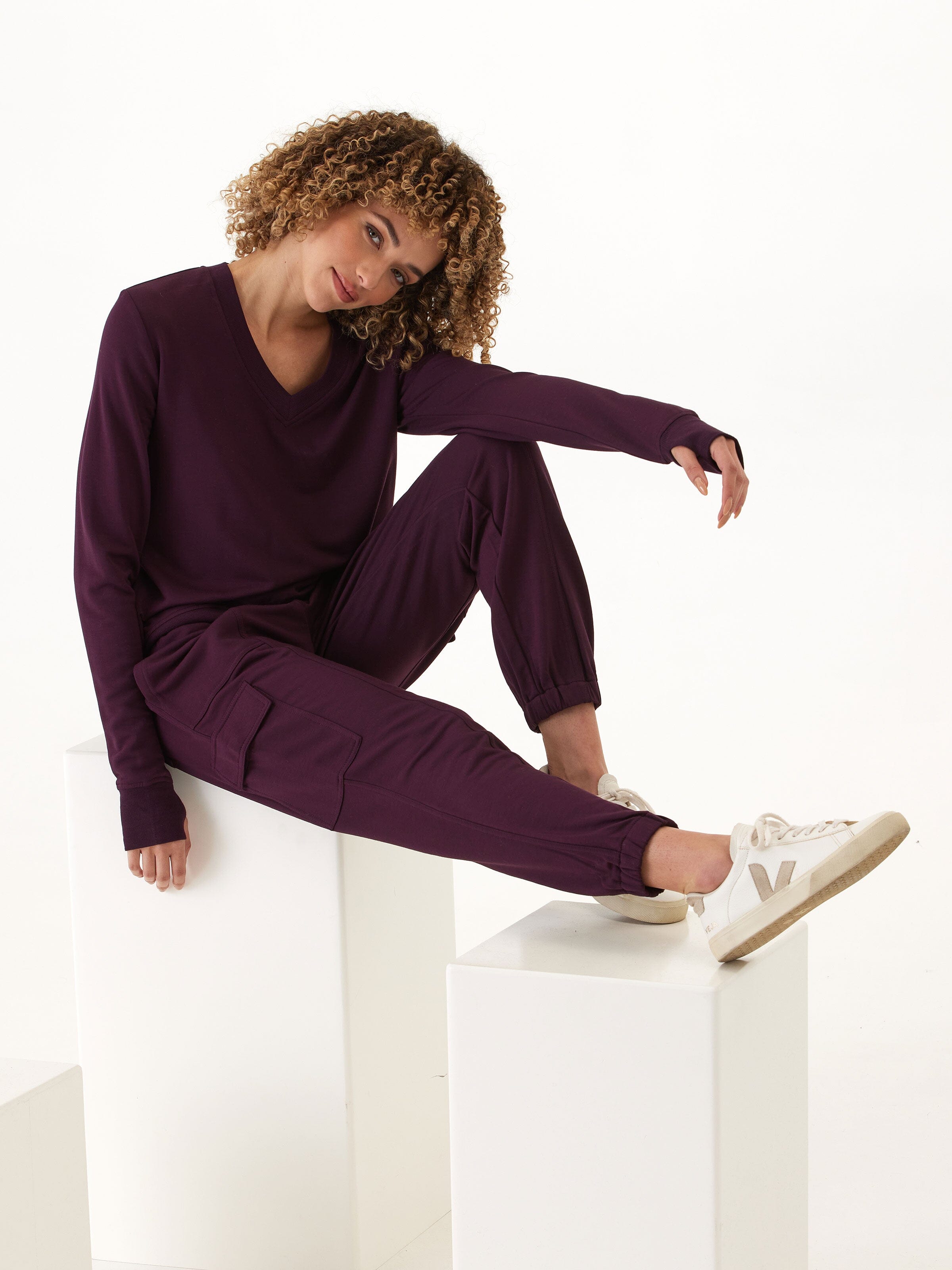 Close up of Margot Feather Fleece Cargo Jogger in deep-plum, showing texture and cargo pocket detail.