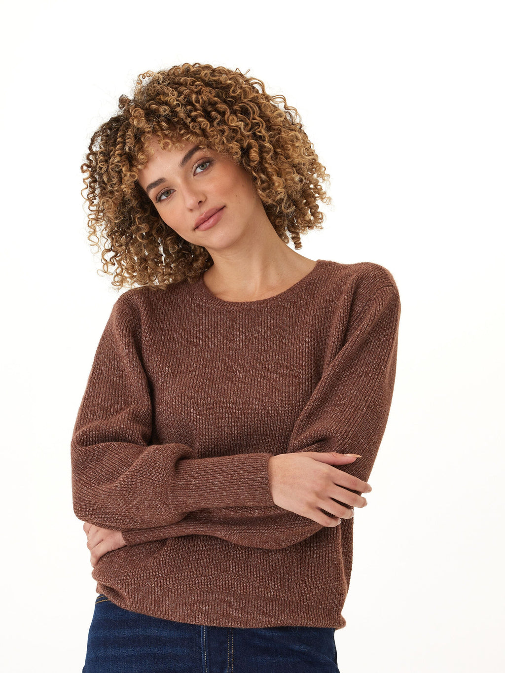 Woman wearing a cozy brown ribbed knit crewneck sweater with long sleeves