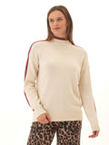 Woman wearing a cream cotton blend mock neck turtleneck sweater with contrast sleeve stripes
