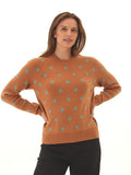Woman wearing a relaxed-fit Deandra polka dot crewneck knit sweater in rust-orange