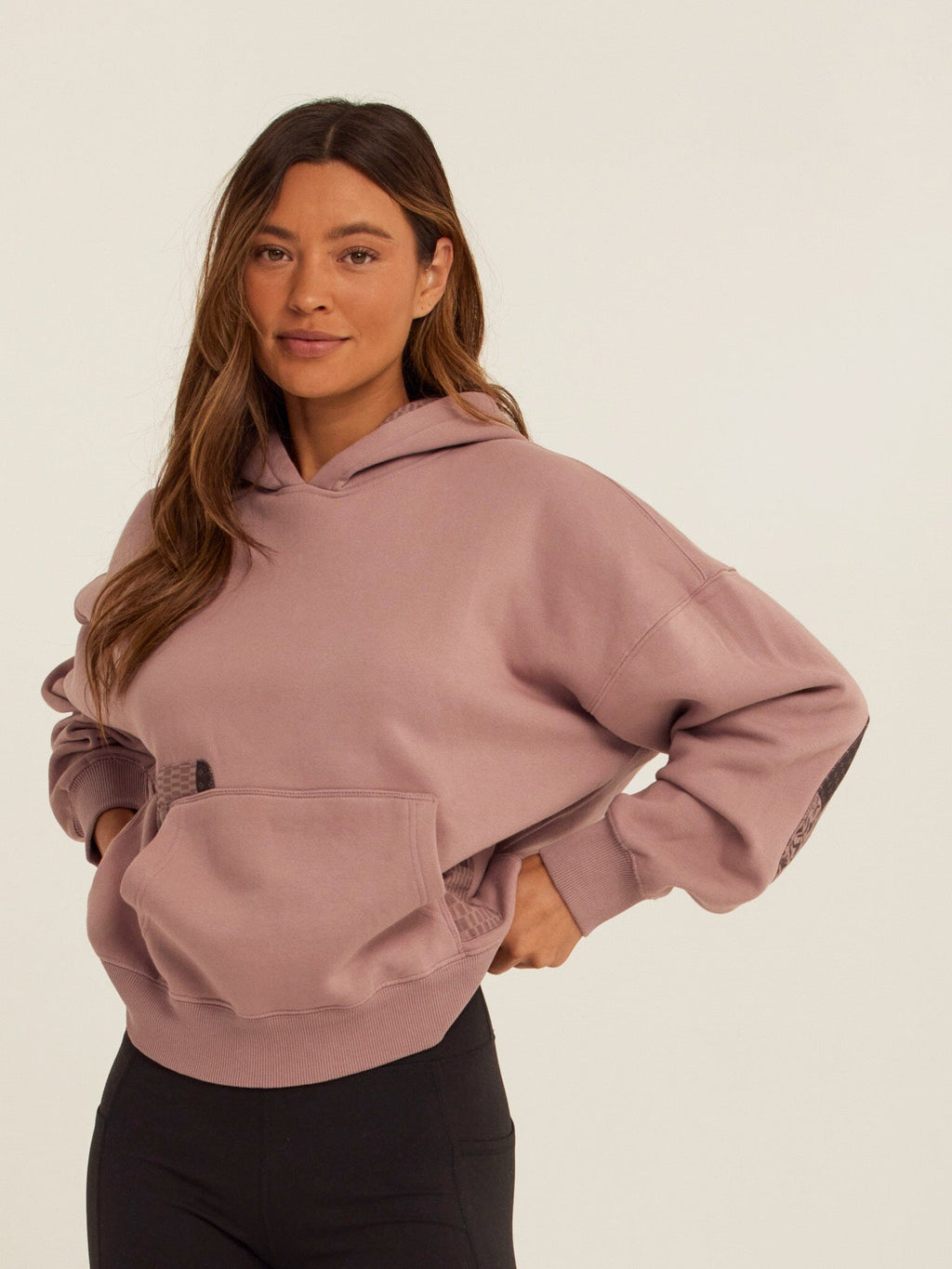 Oversized dusty-rose vintage wash hoodie with dark-grey and black patchwork elbow details