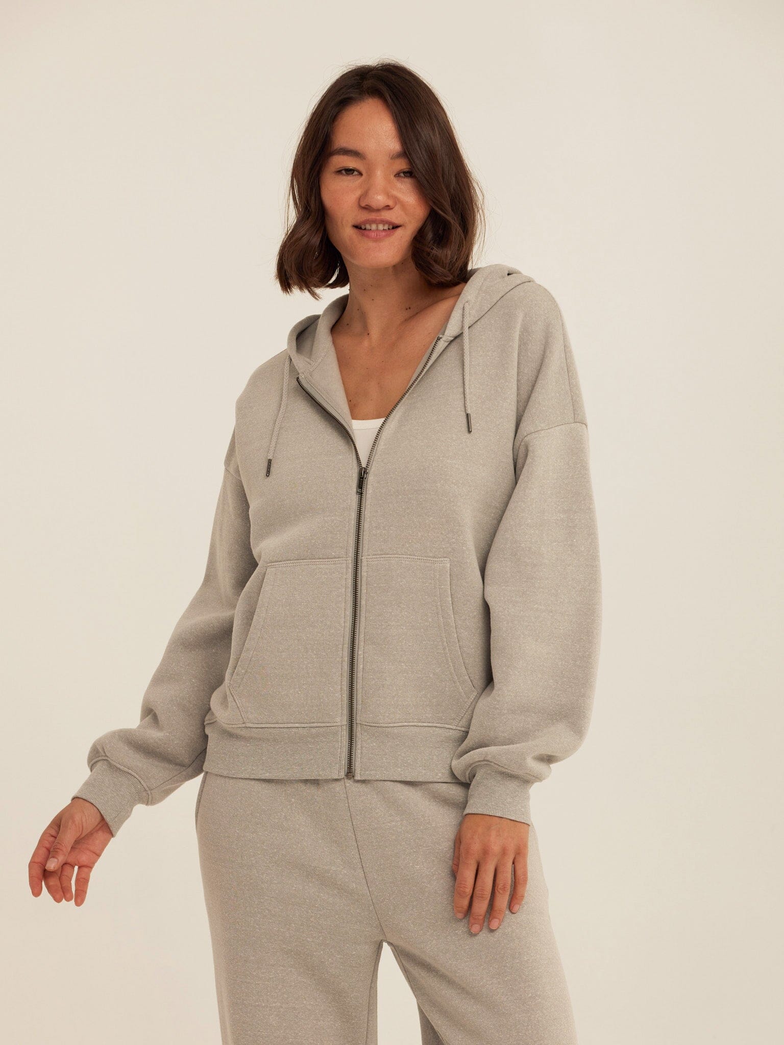 Light Grey Core Triblend Fleece Zip Sweatshirt, showcasing the knit fabric and zip closure.