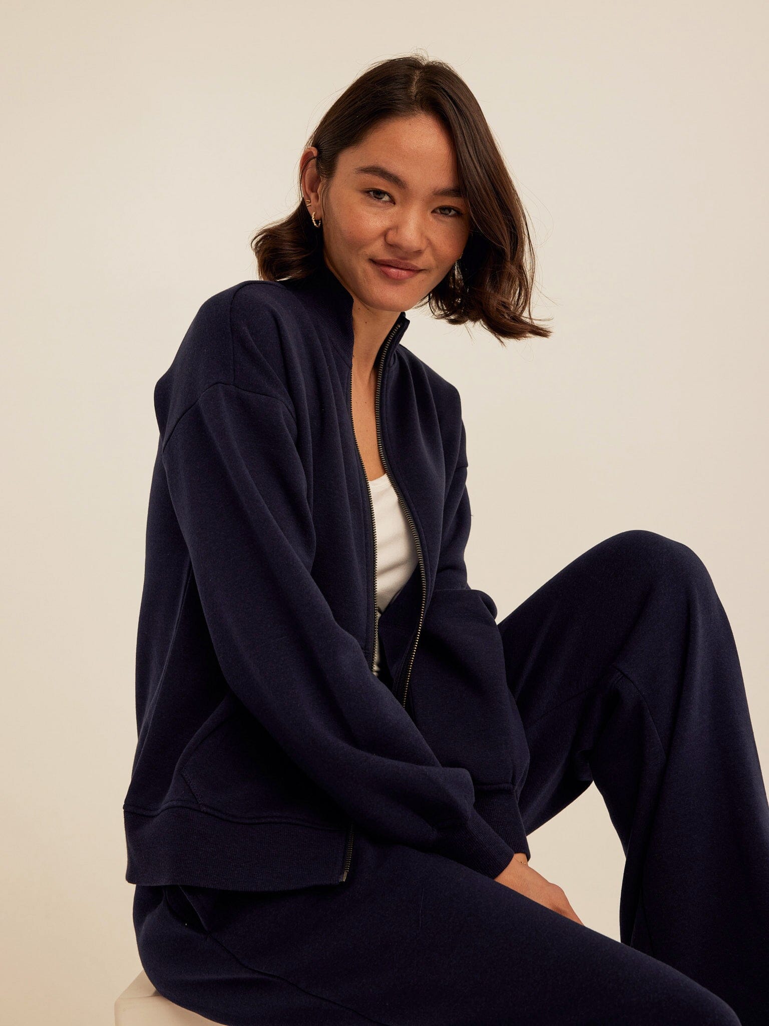 Women's navy blue Delacey Triblend Fleece zip-up jacket with stand collar and side pockets.