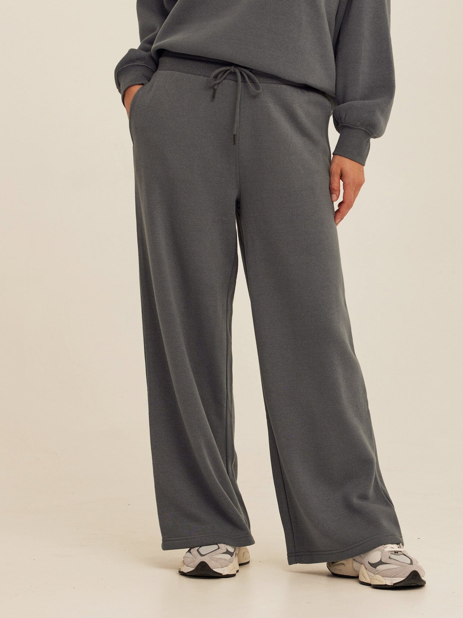 Close up of Core Triblend Fleece Sweatpant in a relaxed wide-leg silhouette with side pockets and drawcord waistband.