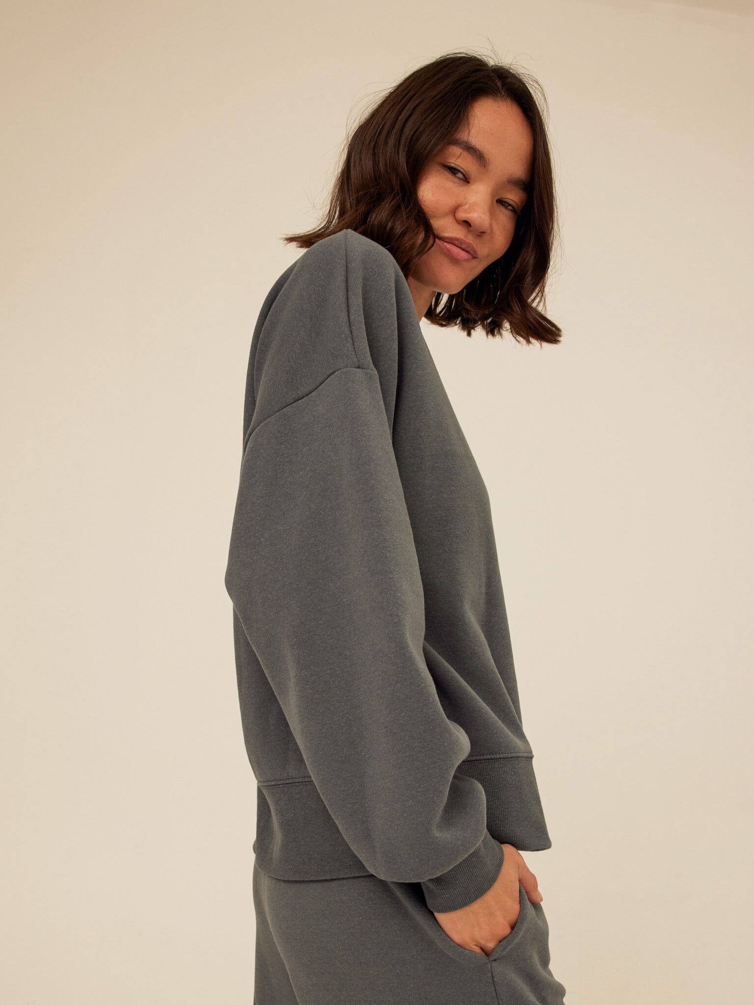 Minimalist charcoal grey knit crew neck sweatshirt with a relaxed fit