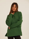 Woman wearing a relaxed-fit deep forest green triblend fleece pullover hoodie with a kangaroo pocket.