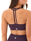 Comfort Fit Sports Bra in dark purple featuring a scoop neck and an elegant strappy back detail.