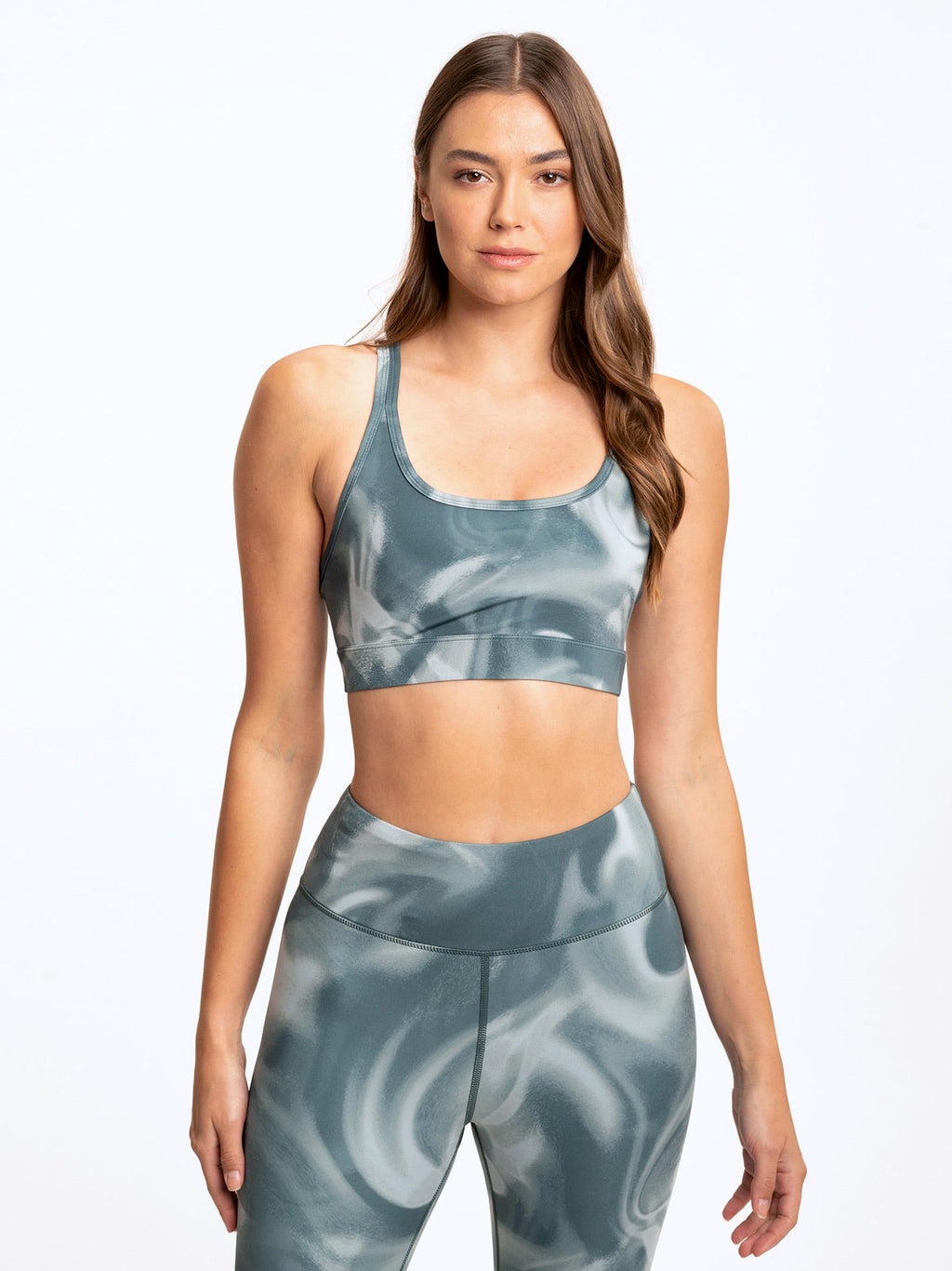 Lotus sports bra in muted teal and white marble print featuring a scoop neckline and cropped fit.