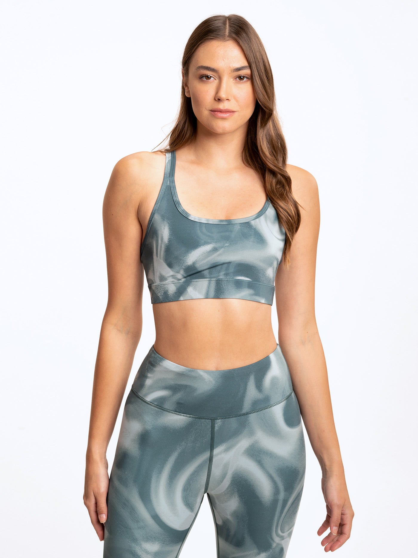 Lotus sports bra in muted teal and white marble print featuring a scoop neckline and cropped fit.