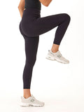 Black 7/8 length high rise sport leggings featuring side pockets and a subtle logo on the back waistband.