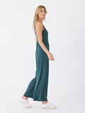 A comfortable Luxe Jersey Jumpsuit featuring a stretchy fabric and side pockets, styled for casual daily wear.