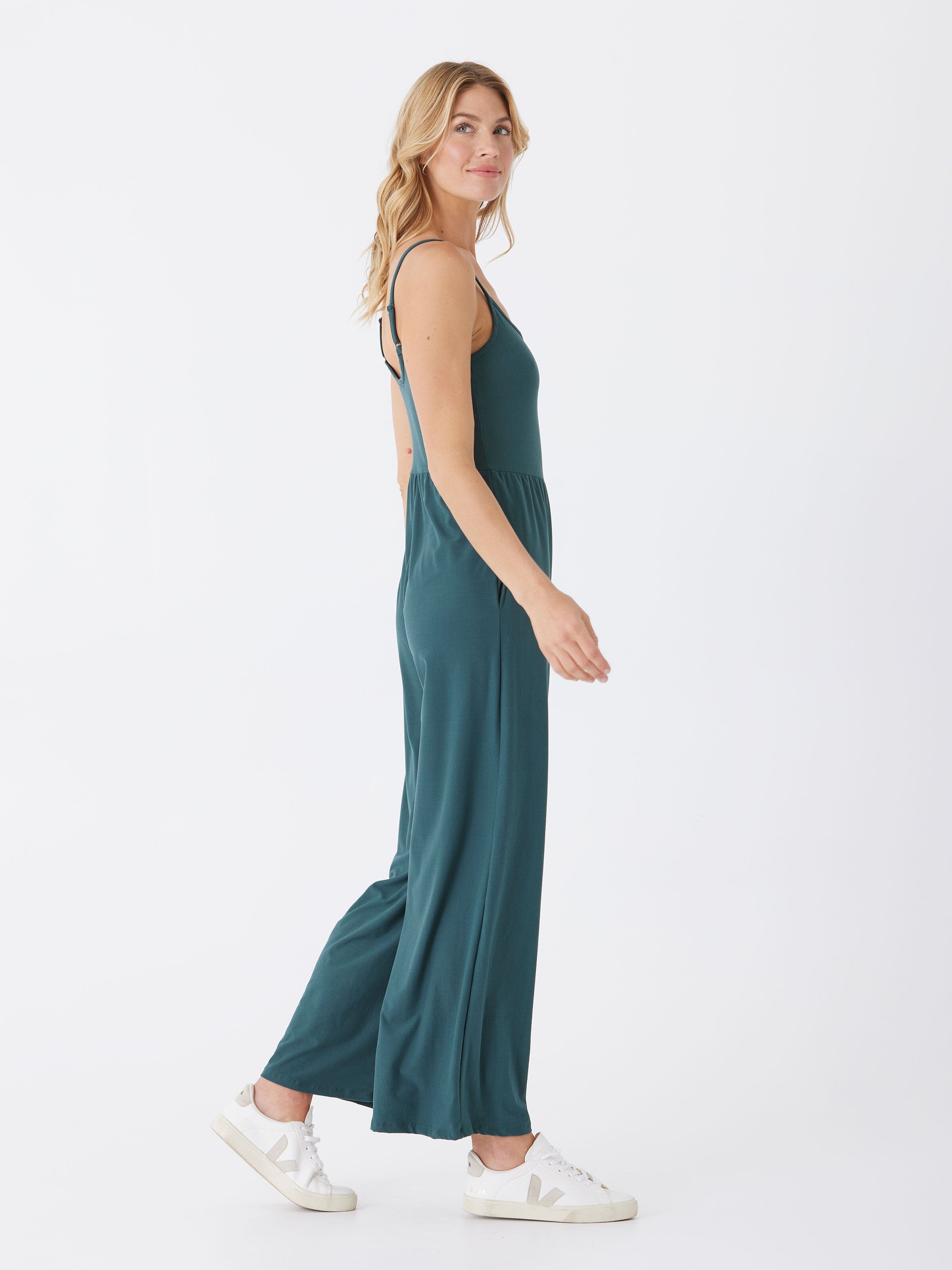 A comfortable Luxe Jersey Jumpsuit featuring a stretchy fabric and side pockets, styled for casual daily wear.