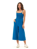 Woman wearing a sleeveless, wide-leg royal blue knit jumpsuit with a square neckline