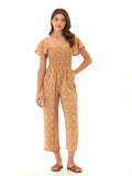 Model wearing a Lucille Medallion print woven jumpsuit with a smocked bodice and flutter sleeves