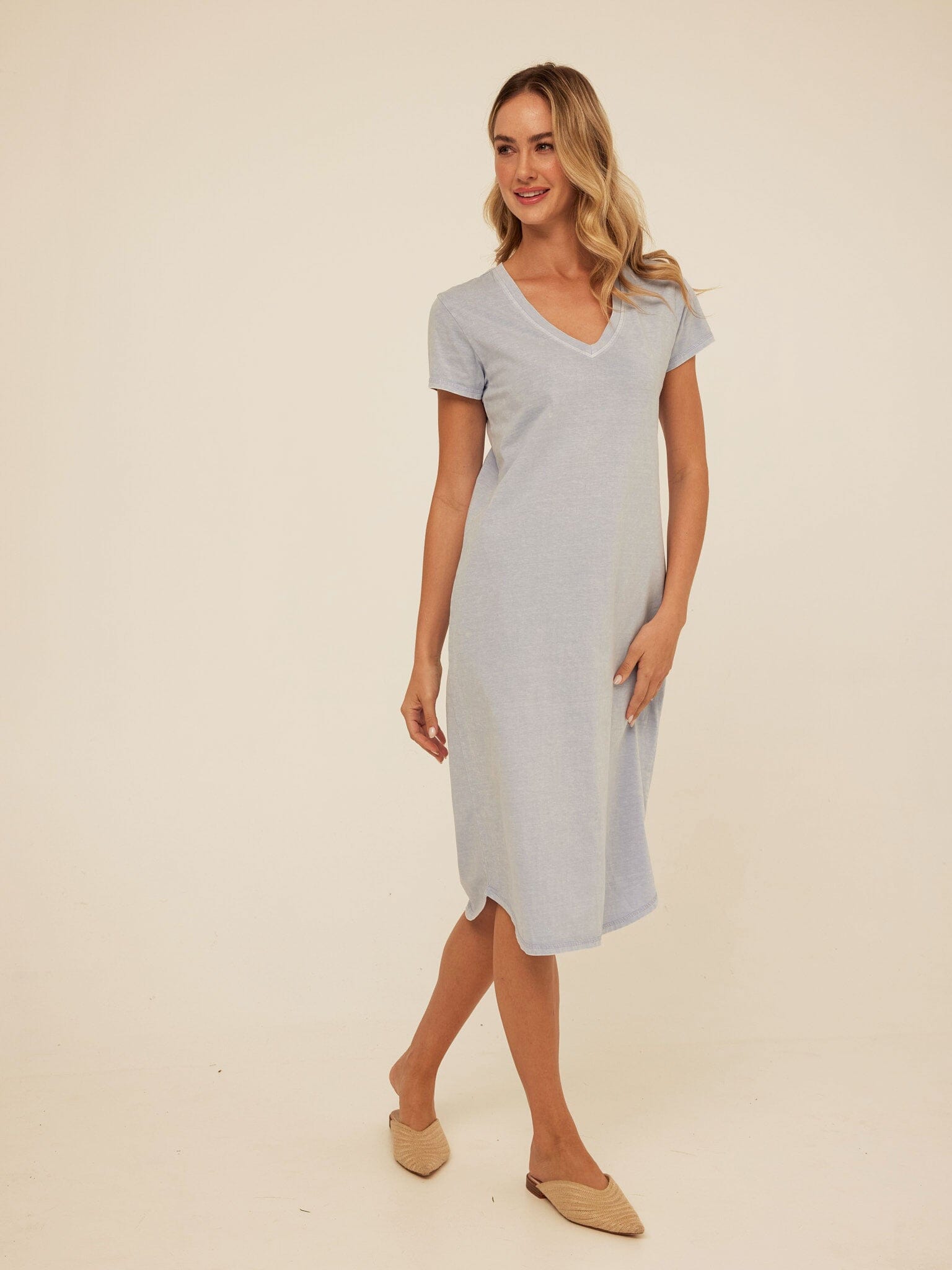 Model wearing a light-blue mineral wash V-neck midi dress with a relaxed shift fit