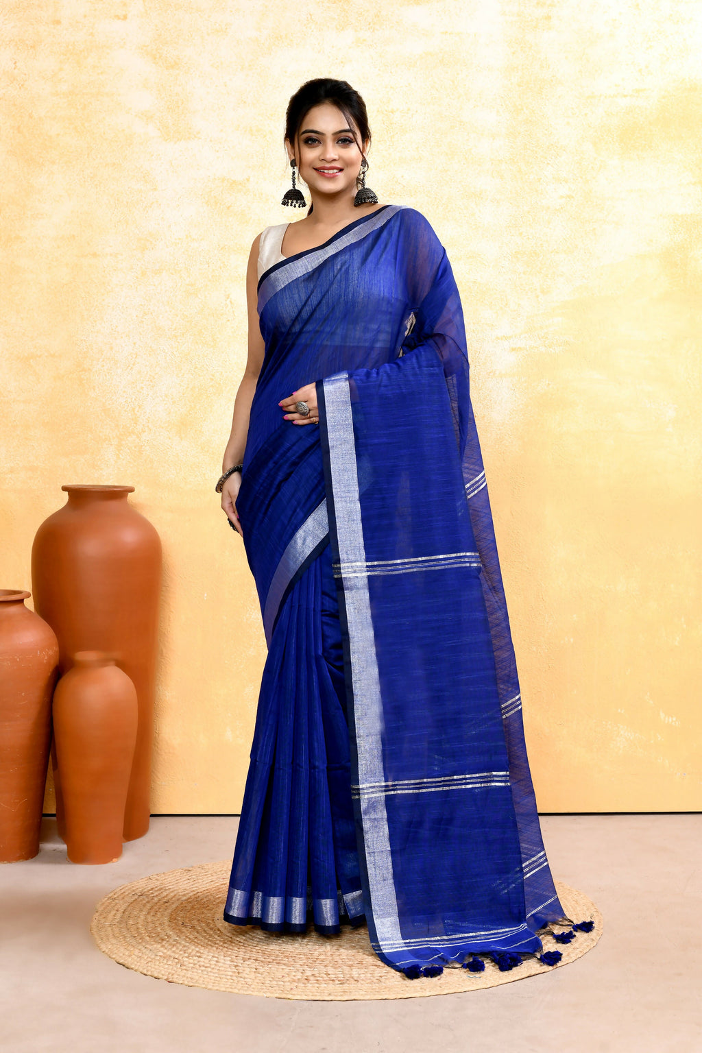 Royal Blue cotton blend handloom saree featuring an intricate gold zari border and embellishments.