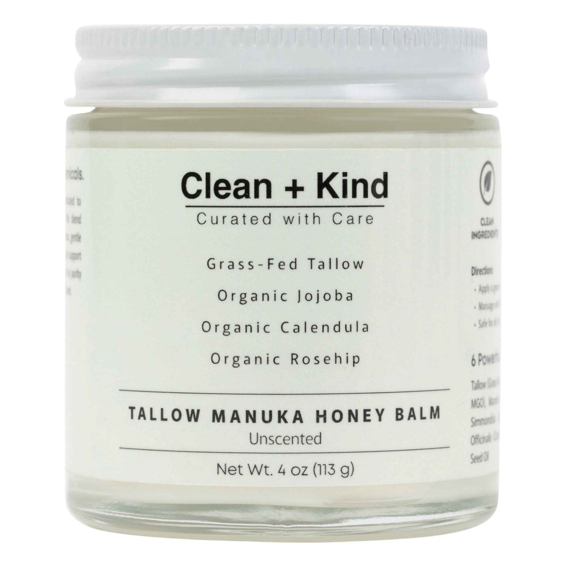 Close up of a glass jar of Whipped Tallow Manuka Honey Balm held in a hand