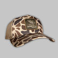White Oak Duck Camo trucker hat featuring a tan woven patch