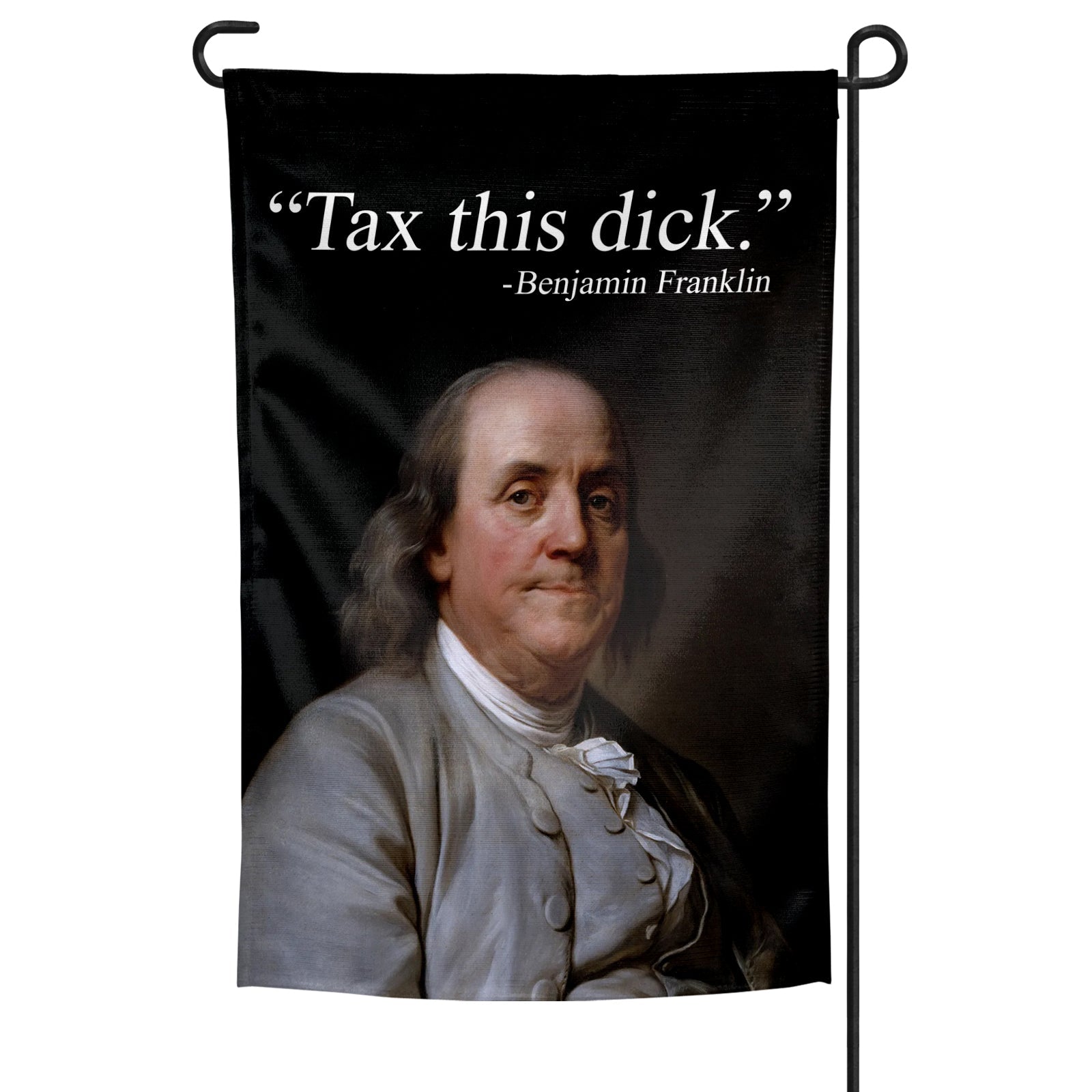 Black and white Benjamin Franklin garden flag with satirical tax text installed in a grassy lawn.