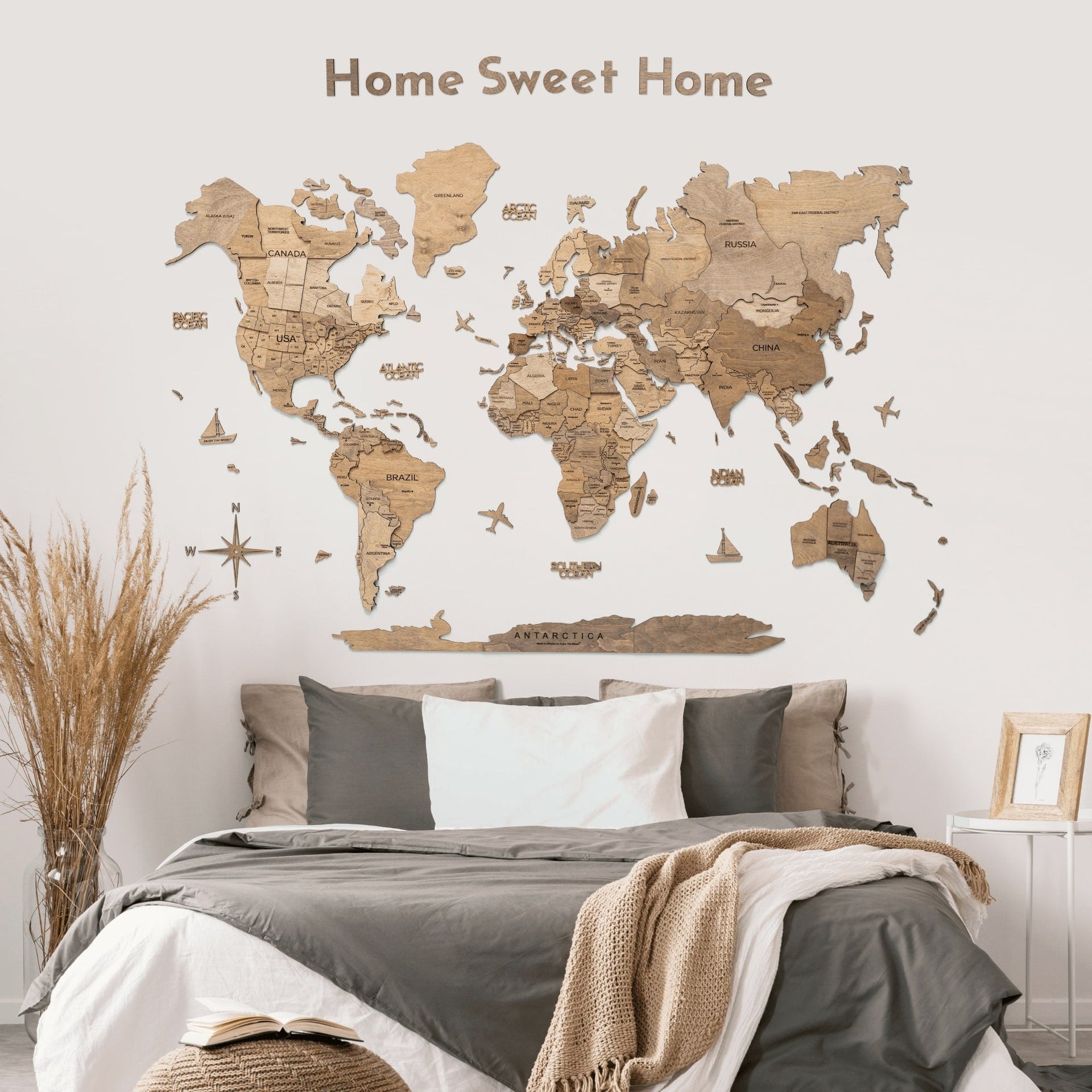 A large, earth-toned Terra wooden quote sign displayed on a minimalist gallery wall in a modern living room.