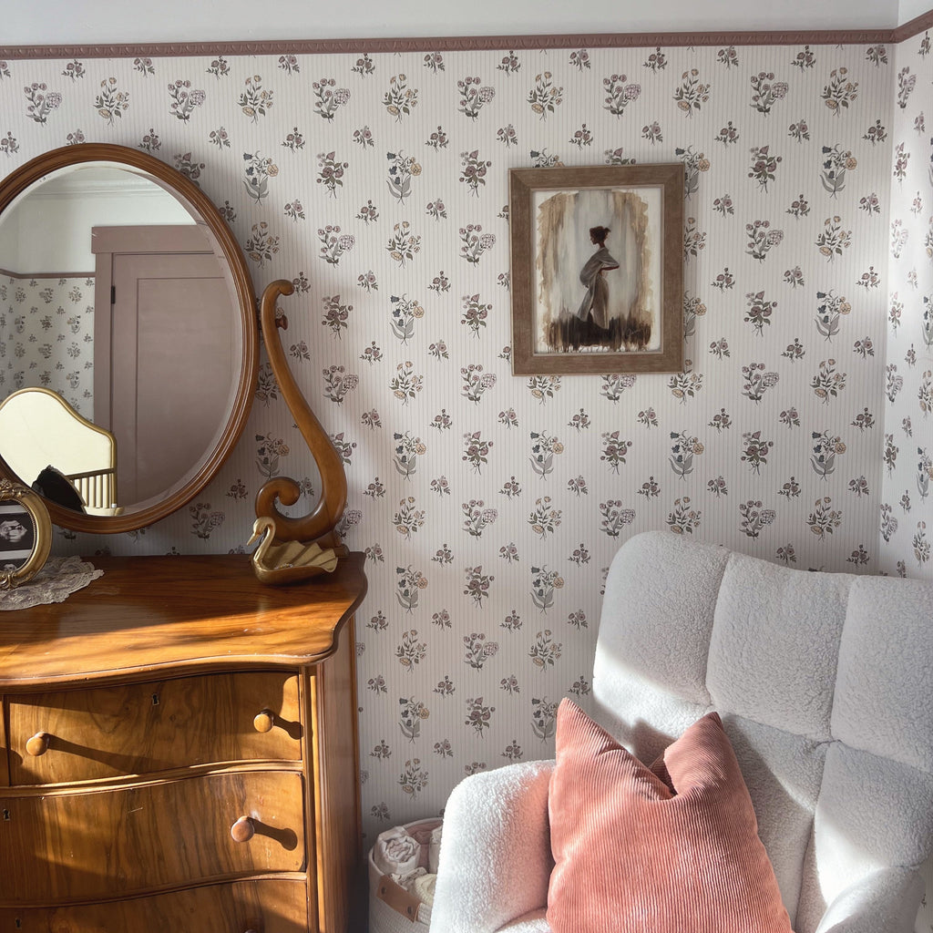 Cosie floral wallpaper featuring a vintage-inspired palette of cream, pale pink, sage green, and muted blue.