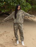 The Sacrifice unisex camo hoodie featuring green, brown, and tan camouflage print for a streetwear aesthetic.