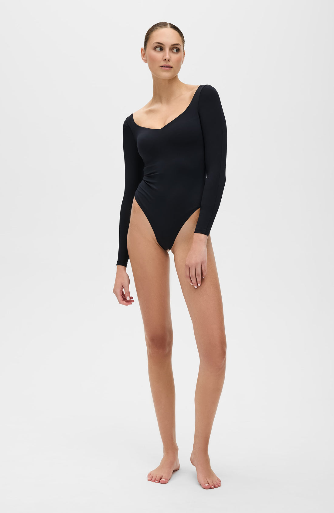 Black Iconic long sleeve thong bodysuit with compression fit on model