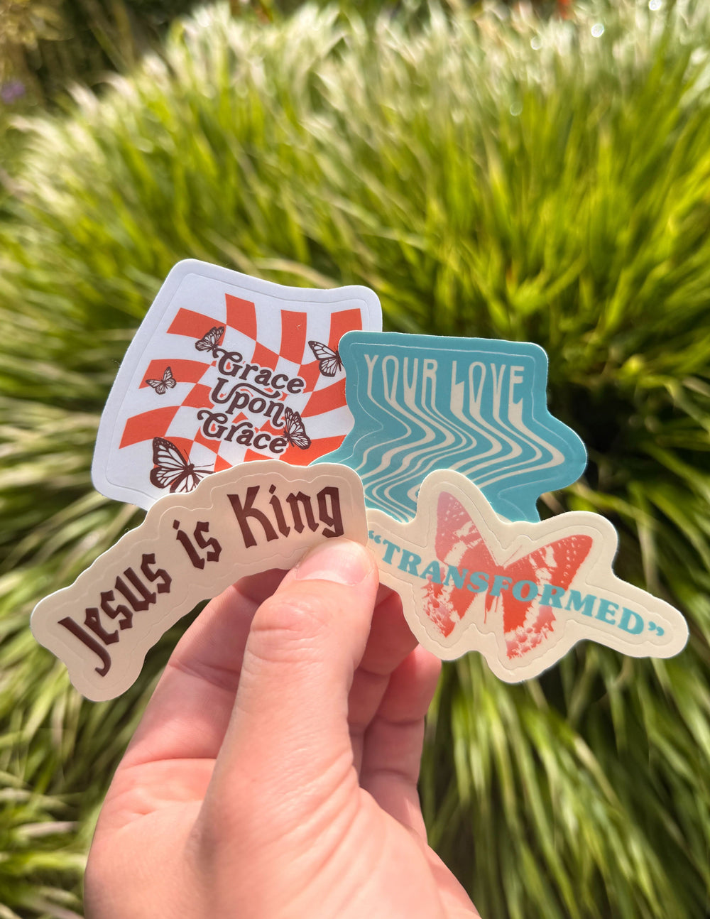 Set of four Y2K-inspired retro vinyl stickers with abstract graphics in red, blue, pink, and brown.