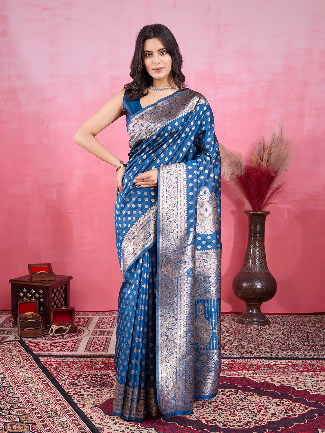 Woman wearing a deep peacock blue Morpinch Banarasi silk saree with silver metallic zari jacquard work