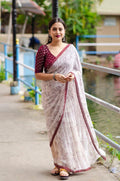 Maroon Georgette saree with Warli prints, aari mirror work, and unstitched tie & dye Banarasi silk blouse.