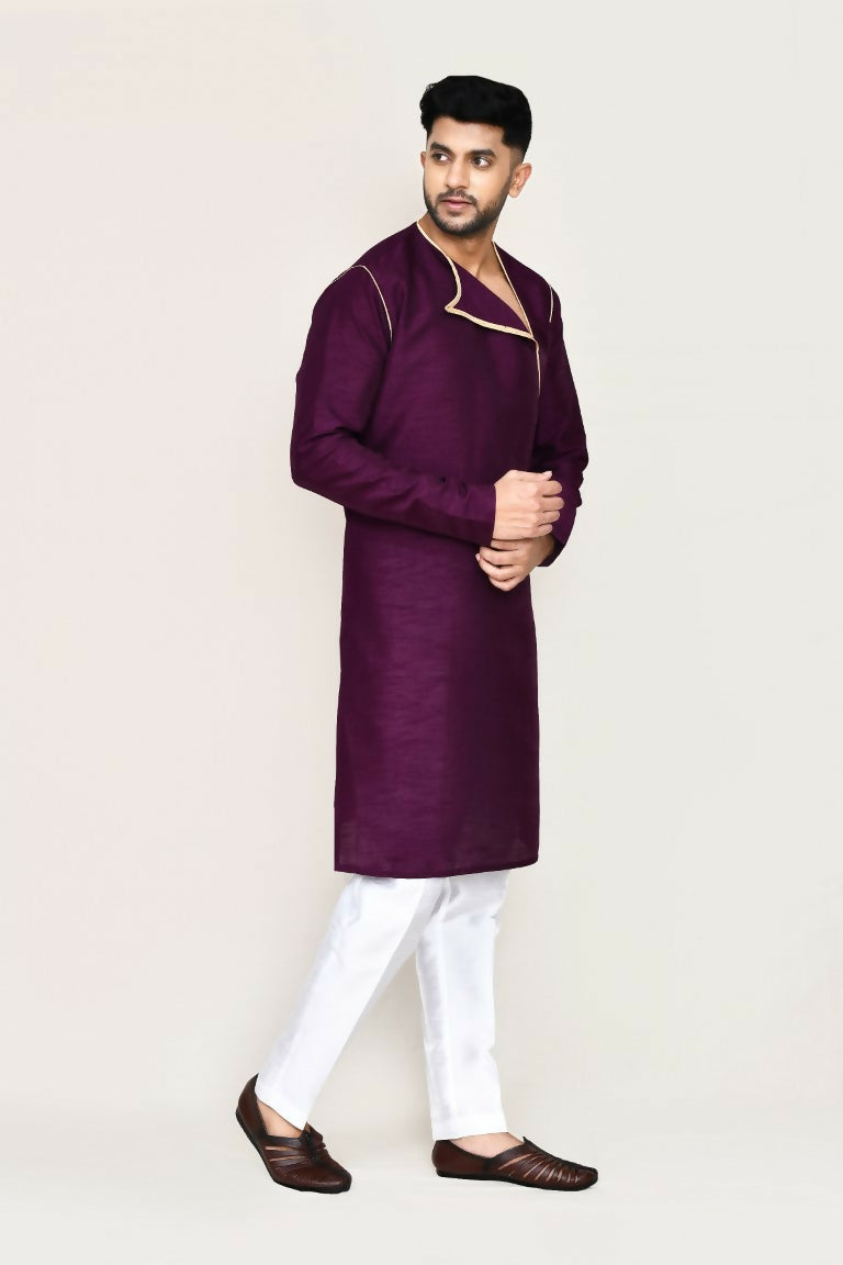 Model wearing a purple art silk kurta with matching straight fit pants for a festive occasion.
