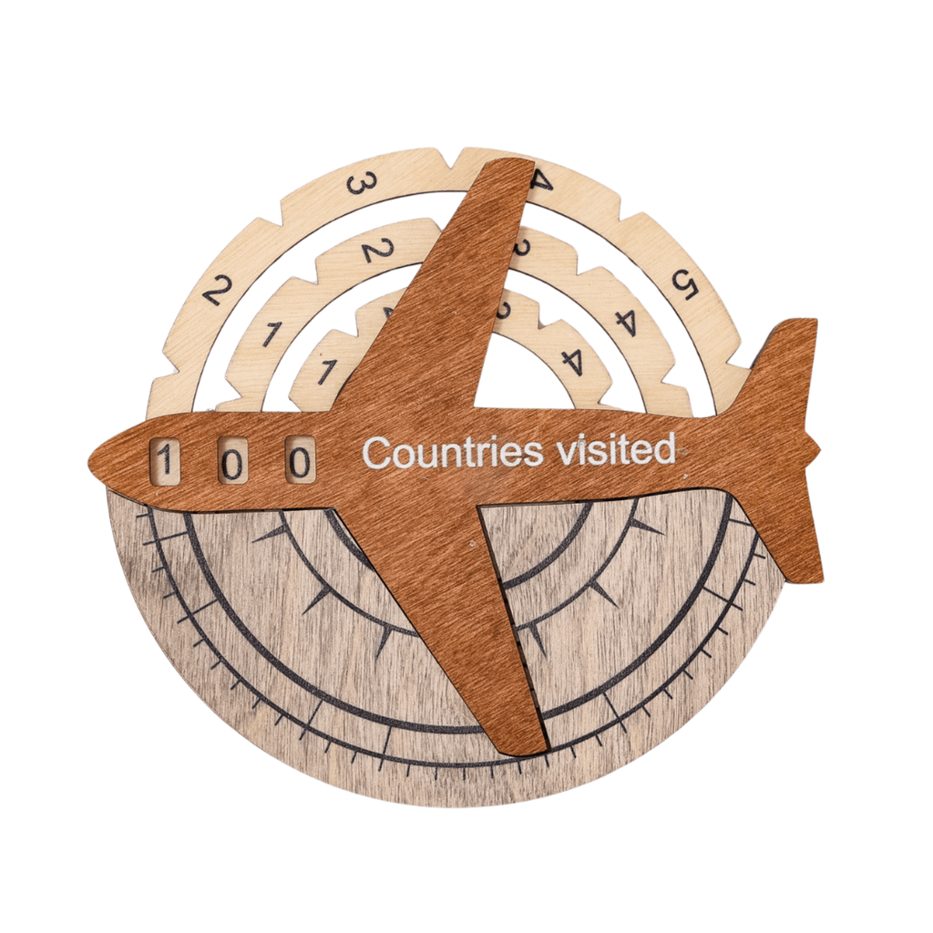 Multicolor 3D wooden world map wall art installed on a neutral wall, featuring travel pins and vibrant colors.