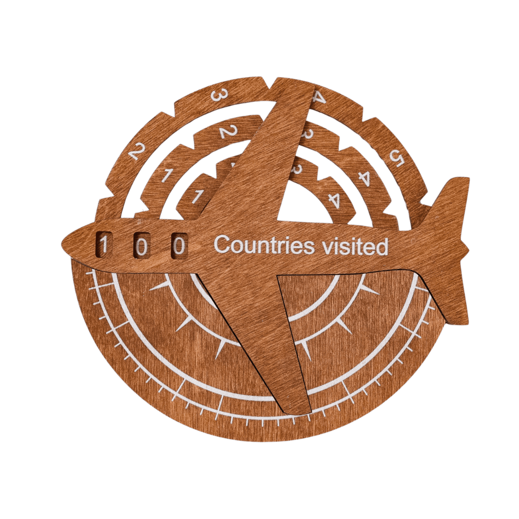 3D wooden world map travel tracker made of oak with white accents on a neutral wall.
