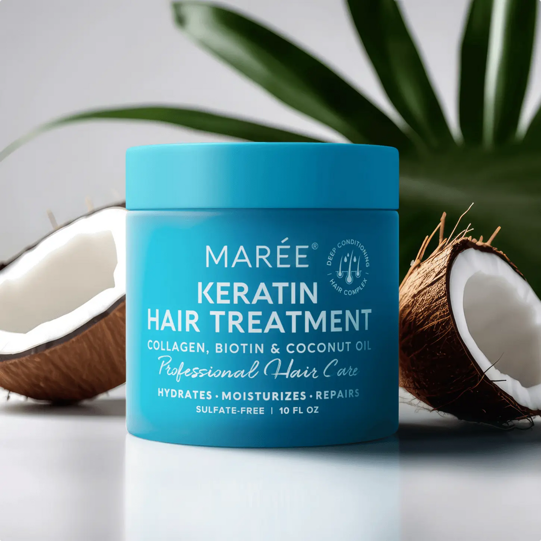 Blue jar of Keratin Hair Treatment sitting next to halved coconuts