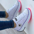 Women's high top canvas sneakers featuring a T-strap design and pointed toe