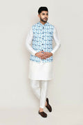 Man wearing a crisp white art silk kurta set with a jacket and straight-cut trousers