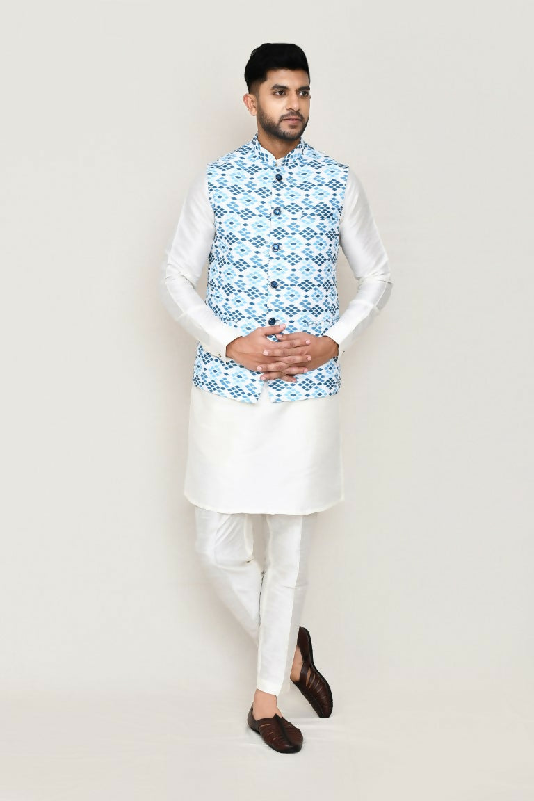 Man wearing a crisp white art silk kurta set with a jacket and straight-cut trousers