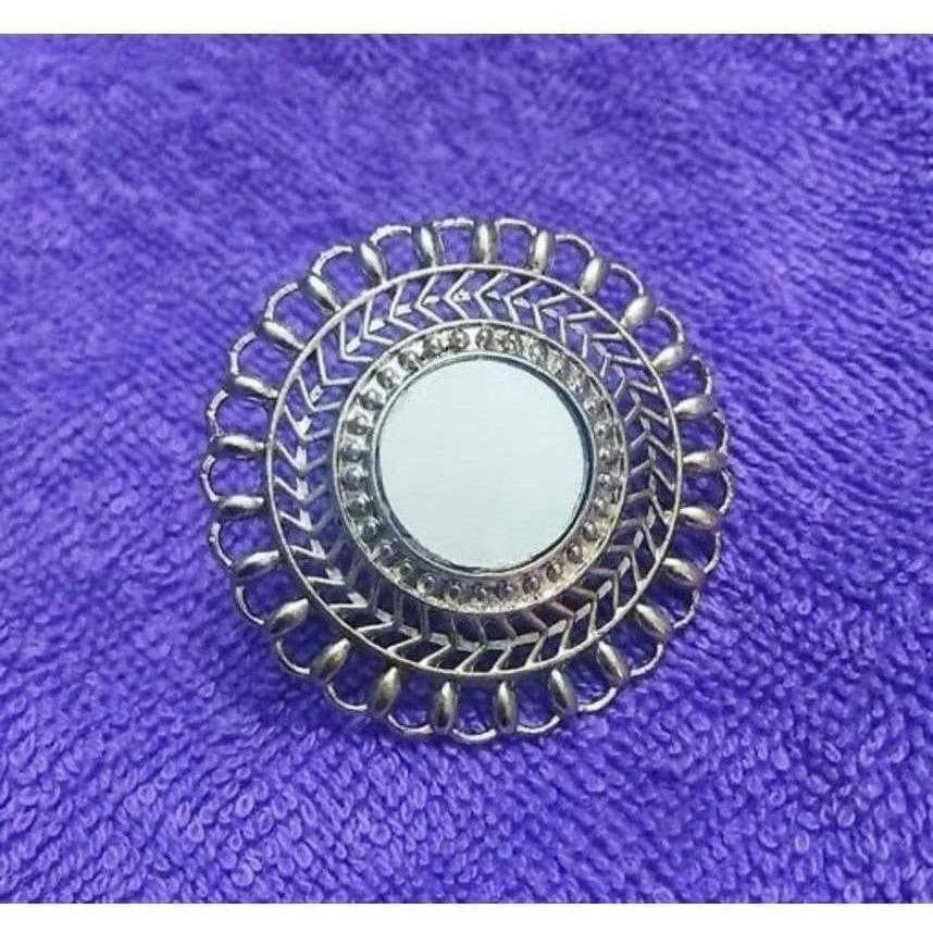 Close-up of an elegant designer fashion ring for women featuring intricate detailing and a polished finish.